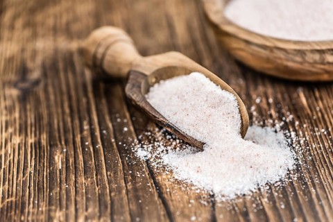 Pink Himalayan Salt on an old wooden table as detailed close-up shot (selective focus)