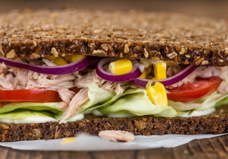 Old wooden table with Tuna sandwich (on wholemeal bread, selective focus)