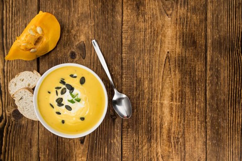 Homemade Pumpkin Soup (selective focus) on rustic background as close-up shot