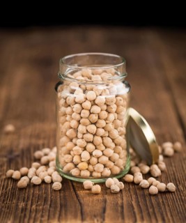 Chickpeas on a vintage background as detailed close-up shot, selective focus