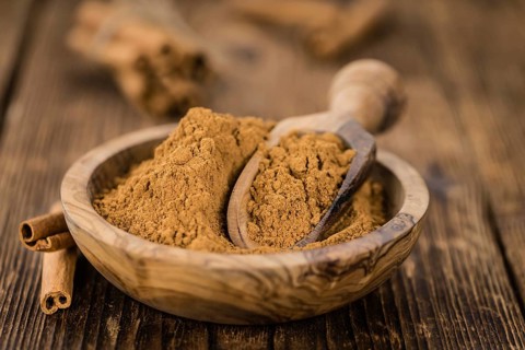Fresh made Cinnamon Powder on a vintage background (close-up shot)
