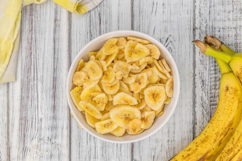Fresh made Dried Banana Chips on an old and rustic wooden table, selective focus, close-up shot