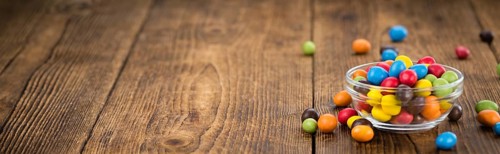 Cocolate coated Peanuts on an old wooden table as detailed close-up shot (selective focus)