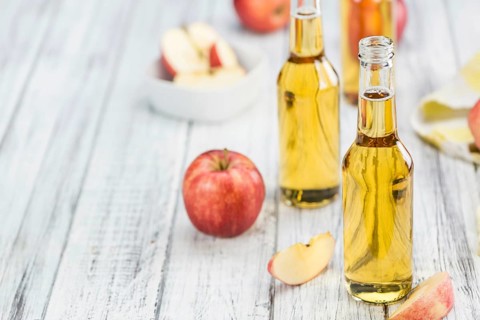 Fresh made Apple Cider on a vintage background (close-up shot)