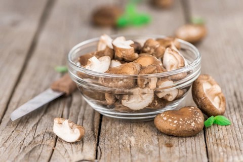 Shiitake mushrooms on a vintage background as detailed close-up shot, selective focus
