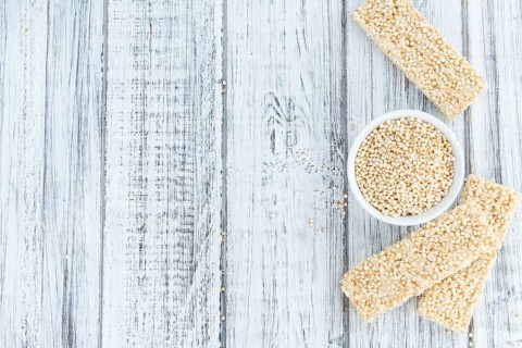 Fresh made Quinoa Bars (selective focus, close-up shot) on an old wooden table