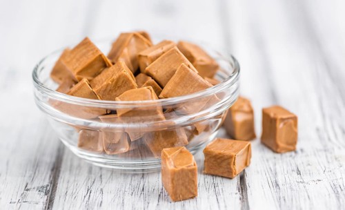 Caramel on a vintage background as detailed close-up shot (selective focus)