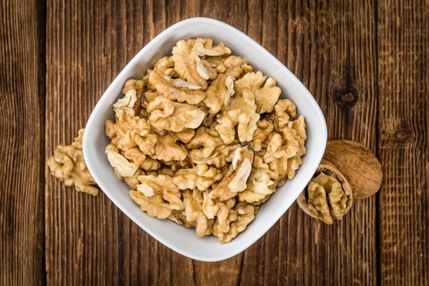 Walnut kernels on a vintage background as detailed close-up shot (selective focus)