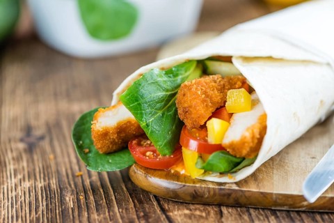 Fresh made Chicken Wraps on an vintage background (selective focus)