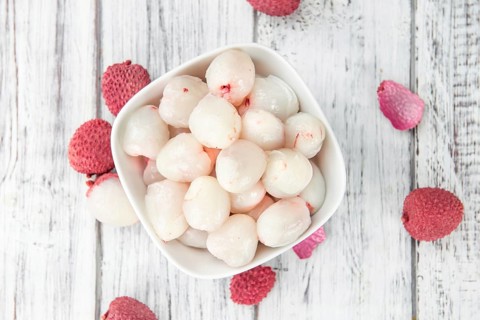 Lychees on a vintage background as detailed close-up shot (selective focus)