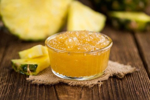 Fresh made Pineapple Jam on a vintage background as detailed close-up shot
