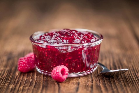 Fresh made Raspberry Jam on a vintage background as detailed close-up shot
