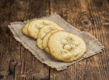 Wooden table with Cookies (detailed close-up shot, selective focus)