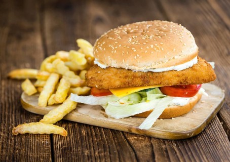 Fish Burger (selective focus, close-up shot) on wooden background