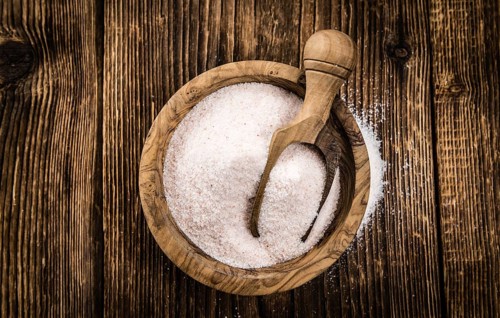 Himalayan Salt as high detailed close-up shot on a vintage wooden table (selective focus)