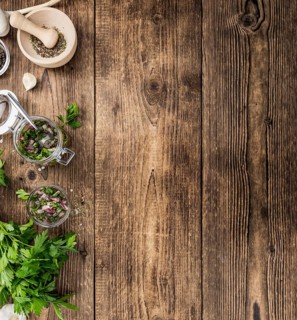 Healthy homemade Chimichurri on a wooden table as detailed close-up shot (selective focus)