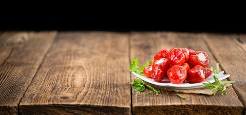 Fresh made Red Pepper (stuffed with cheese) on an old and rustic wooden table (selective focus,