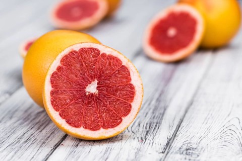 Grapefruits slices (selective focus) on a vintage background as detailed close-up shot