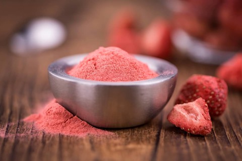Fresh made Strawberry powder on a vintage background as detailed close-up shot