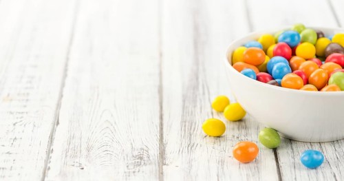 Cocolate coated Peanuts on a vintage background as detailed close-up shot (selective focus)