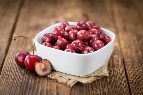 Preserved Cherries on a vintage background as detailed close-up shot, selective focus