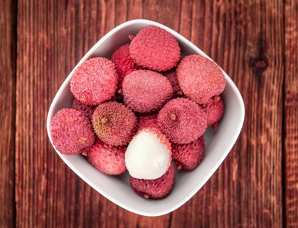 Lychees on a vintage background as detailed close-up shot (selective focus)