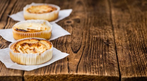 Homemade Cheesecake on an wooden table (selective focus) as detailed close-up shot
