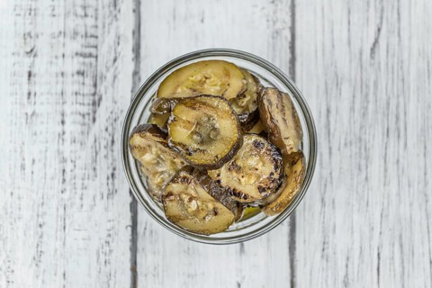 Fresh made Zucchinis (grilled) on an old and rustic wooden table (selective focus, close-up shot)