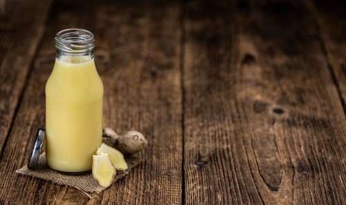Portion of healthy Ginger Drink (selective focus, close-up shot)