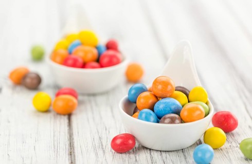 Fresh made Cocolate coated Peanuts on a vintage background (close-up shot)