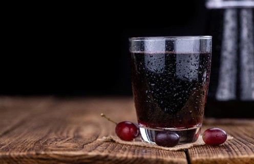Some fresh Red Grape Juice (selective focus, close-up shot)