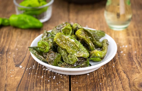 Pimientos de Padron on a vintage background as detailed close-up shot, selective focus