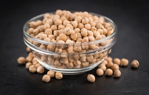 Chickpeas on a vintage background as detailed close-up shot, selective focus