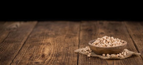 Chickpeas on a vintage background as detailed close-up shot, selective focus
