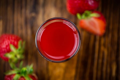 Fresh made Strawberry liqueur on an old and rustic wooden table, selective focus, close-up shot