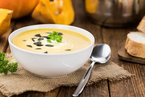 Homemade Pumpkin Soup (selective focus) on rustic background as close-up shot