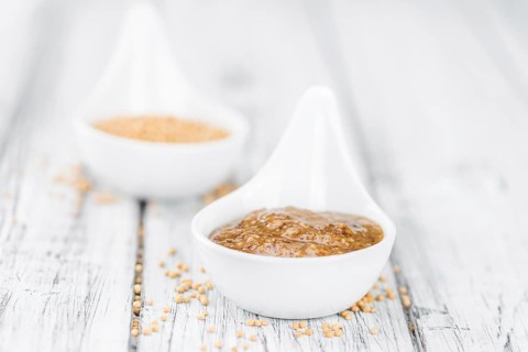 Fresh made German Cuisine (sweet Mustard) on a vintage background (close-up shot)