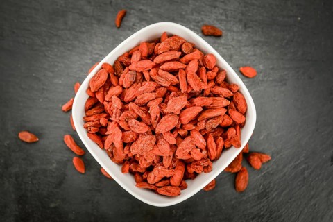 Some Dried Goji Berries on a slate slab (close-up shot, selective focus)