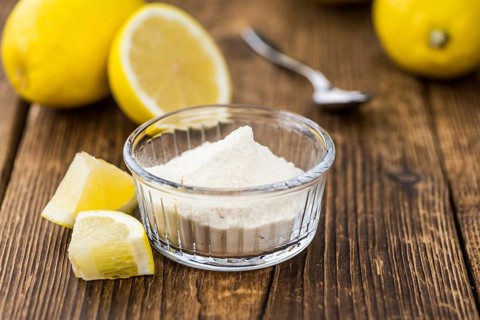 Wooden table with Lemon powder (detailed close-up shot, selective focus)