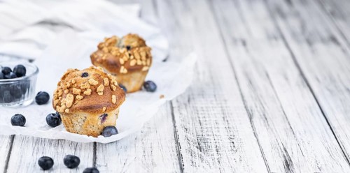 Fresh Blueberry Muffins as detailed close-up shot (selective focus)