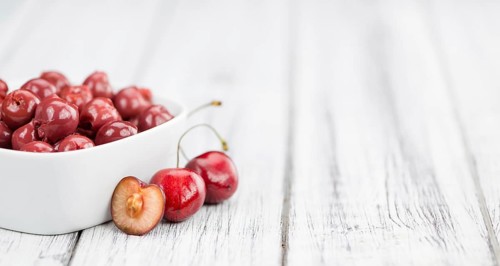 Fresh made Canned Cherries on a vintage background as detailed close-up shot