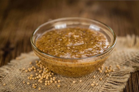 Sweet Mustard on a vintage background as detailed close-up shot (selective focus)