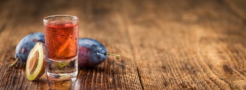 Plum Liqueur on a vintage background as detailed close-up shot, selective focus