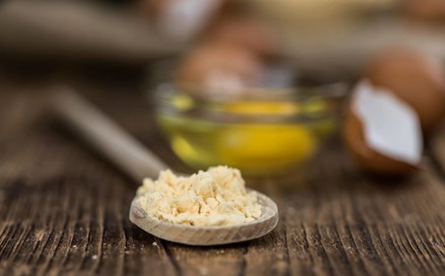 Vintage wooden table with Powdered Eggs (selective focus, close-up shot)