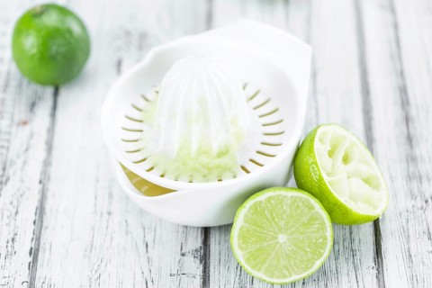 Lime Juice on a vintage background as detailed close-up shot (selective focus)
