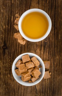 Caramel Sirup on a vintage background as detailed close-up shot (selective focus)