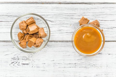 Caramel Sauce on a vintage background as detailed close-up shot (selective focus)