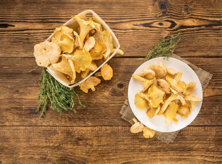 Fresh harvested Chanterelles (on a wooden table) as detailed close-up shot