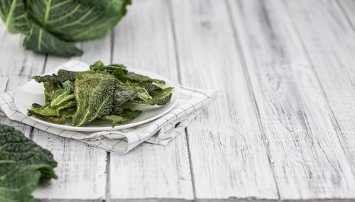 Vintage wooden table with Savoy Chips (selective focus, close-up shot)