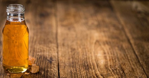 Caramel Sirup on a vintage background as detailed close-up shot (selective focus)